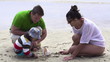 Family on beach with beautiful seashell, super slow motion