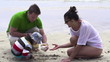 Family on beach with beautiful seashell