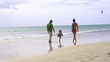 Happy family walking on the beach, super slow motion