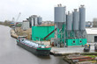 Ship in harbor of the cement plant. Netherlands