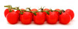 Group of red tomatoes on the vine over white