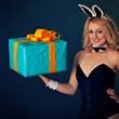 Young rabbit girl with biggest gift on hand