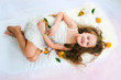 beautiful girl lying among tangerines