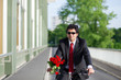 Businessman with bike and roses