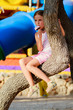 Foto: Lovely girl with ice cream in playground Lovely girl with ice cream in playground