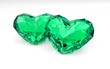 Two emerald hearts on white background