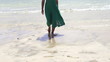 Woman legs walking on the beach, super slow motion