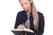 Woman wearing a headset taking notes