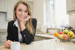Woman drinking coffee at counter
