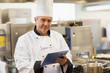 Chef using his digital tablet and looking at camera