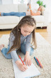 Little girl sitting at the floor