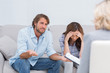 Couple arguing and crying on the couch