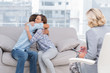 Photo: Young couple cuddling on the couch Young couple cuddling on the couch
