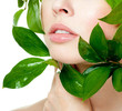 beautiful woman's face, surrounded by green leaves