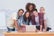 Foto: Creative team standing at desk with laptop Creative team standing at desk with laptop