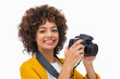 Smiling girl taking a photo and looking at camera