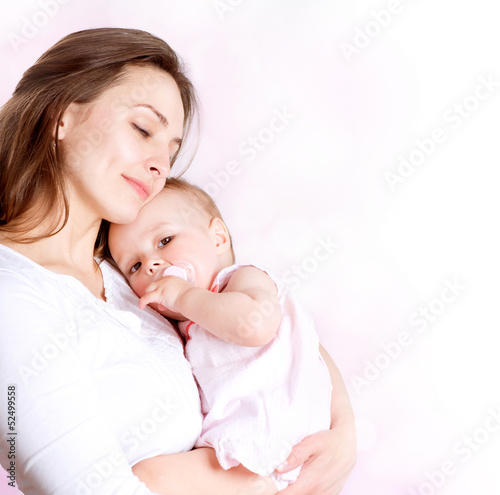 Photo: Mother and Baby kissing and hugging. Happy Family Mother and Baby kissing and hugging. Happy Family