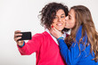 Two Beautiful Women Taking Self Portrait with Mobile Phone
