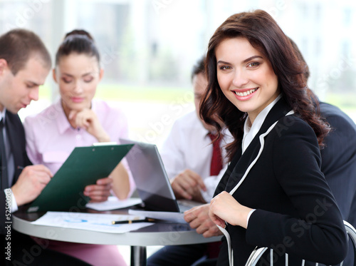 Photo: successful businesswoman and business team at office successful businesswoman and business team at office