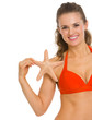 Smiling young woman in swimsuit with starfish