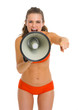 Angry young woman in swimsuit shouting through megaphone