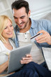 Couple shopping on internet with credit card