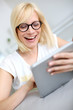 Blond girl websurfing with tablet