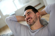 Photo: Relaxed man stretching arms behind head Relaxed man stretching arms behind head