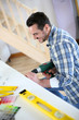 Photo: Man using electric drill in new house Man using electric drill in new house