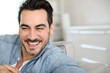 Foto: Handsome middle-aged man relaxing in sofa Handsome middle-aged man relaxing in sofa