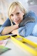 Closeup of blond woman using level