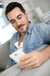 Smiling middle-aged man using smartphone