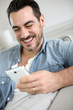 Smiling middle-aged man using smartphone
