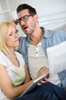Couple reading news with horrified look
