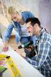 Couple installing furniture in new house