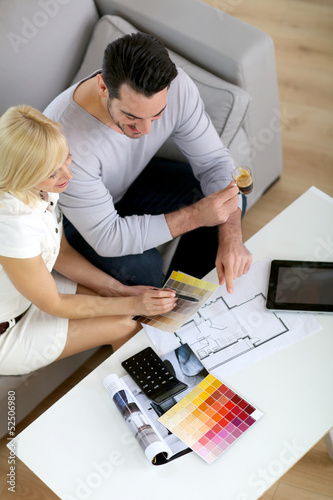 Photo: Couple working on home remodellng Couple working on home remodellng