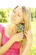 girl with a bouquet of flowers in nature