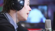 Football soccer male commentator looks at his studio monitor