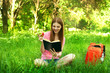 beautiful young girl-student read the book at the park with an a