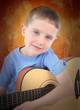 Photo: Young Boy Holding Acoustic Guitar Young Boy Holding Acoustic Guitar