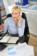 Businesswoman on the phone writing on agenda