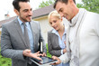 Real-estate-agent showing house plan on digital tablet