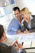 Couple meeting real-estate agent to buy property