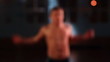 Athletic male doing fitness exercise high jumps in slow motion