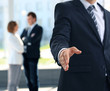 A business man with an open hand ready to seal a deal