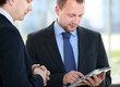 Business partners working with electronic tablet