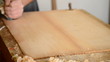 Carpenter or luthier working with wood planer.