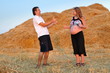 The guy and the pregnant girl on a mow rejoice