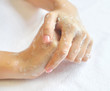 Washing woman hands on a background a white towel