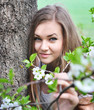 Beautiful woman among spring blossom